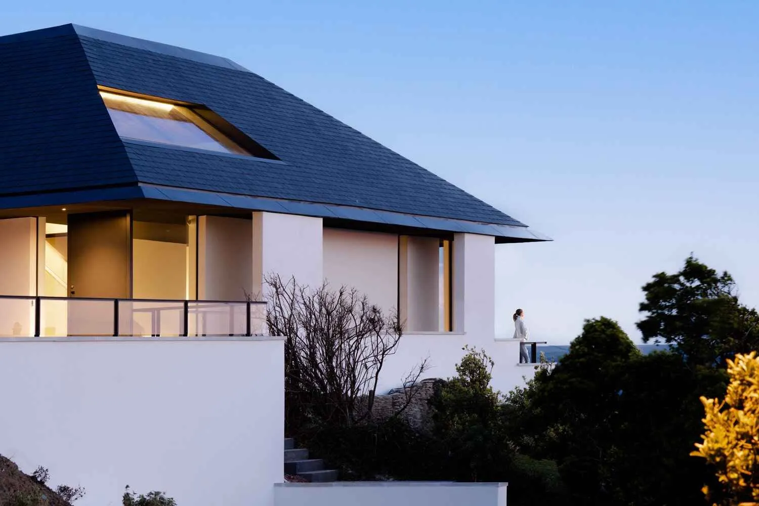 A new house at dusk on a clifftop site, Cove Ridge, Devon