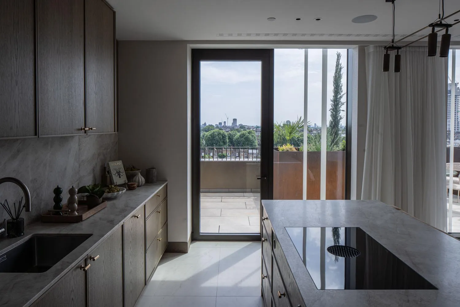 Holland Park Penthouse, Kensington &mdash; kitchen, dark island with terrace view