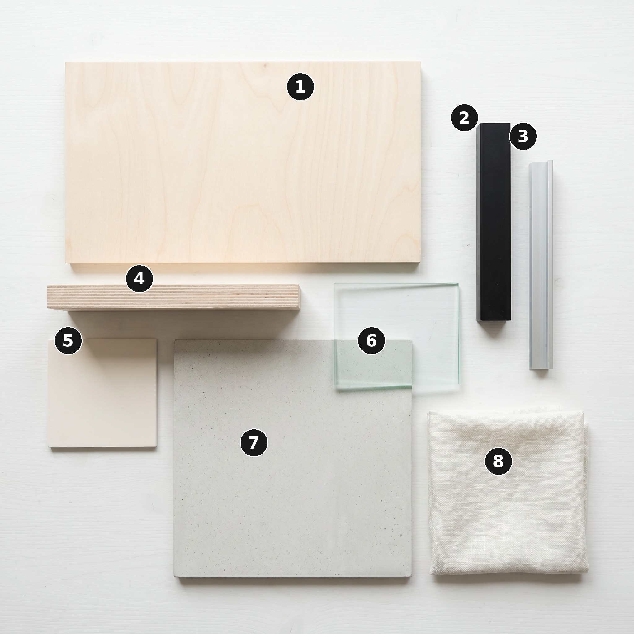 Overhead flat lay of 8 material samples from Folded House, Islington — Pale Baltic birch plywood face veneer, Matte black powder-coated steel, Brushed-silver anodised aluminium frame, Birch plywood end-grain edge, White matt-paint plaster wall, Frameless clear float glass, Pale polished concrete and Off-white linen upholstery — arranged on a soft warm-white painted timber surface.