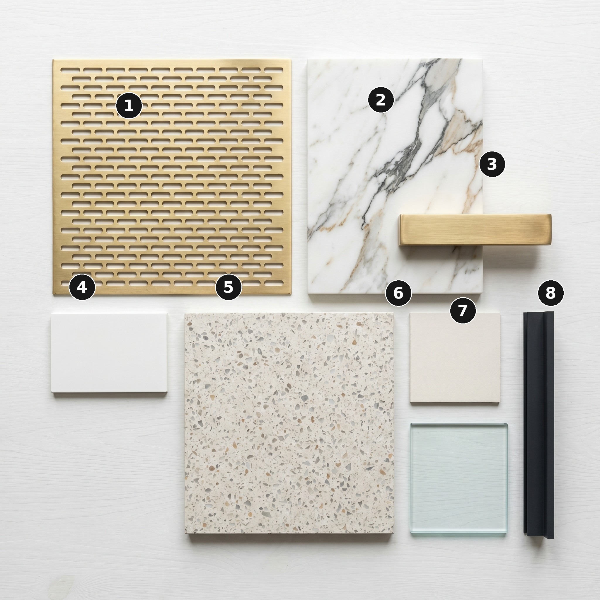 Overhead flat lay of 8 material samples from Helios House, White City — Perforated brass screen, Calacatta marble, Brushed brass, White matt-lacquered MDF, Pale terrazzo, Warm-white matt plaster, Frameless clear float glass and Anthracite-grey powder-coated aluminium frame — arranged on a soft warm-white painted timber surface.